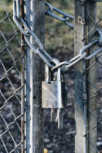 Close-up of padlock on fence