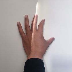 Close-up of hands against white background