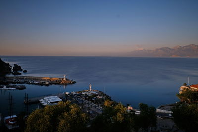 High angle view of townscape by sea against sky