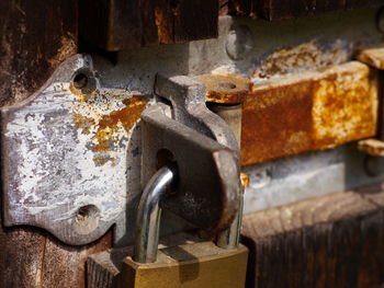 Close-up of padlock on rusty metallic door