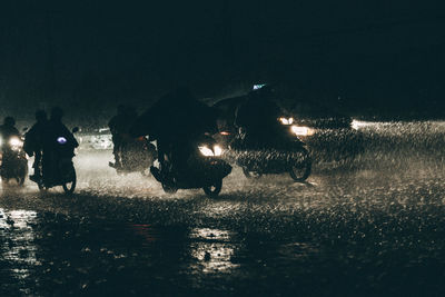 People riding on field at night