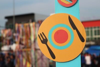 Close-up of restaurant symbol hanging outdoors