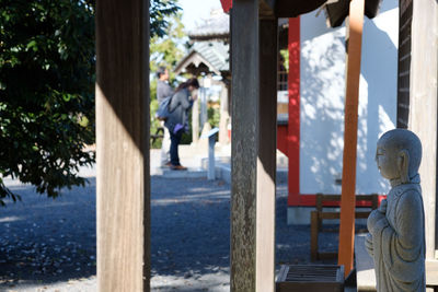 Rear view of man and woman walking in city