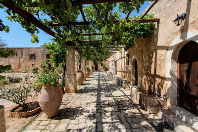 Footpath by old building against sky