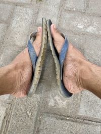 A pair of medium legs wearing black sandals