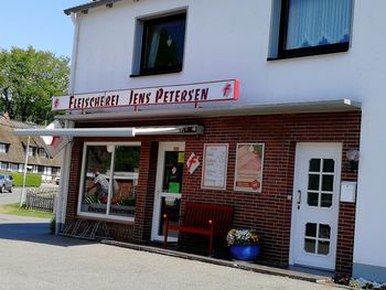 Information sign on street against building