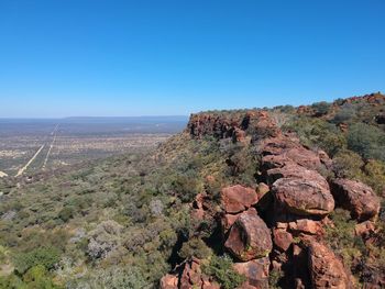 Scenic view of rocky landscape against clear blue sky