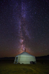 Tent on field against sky at night