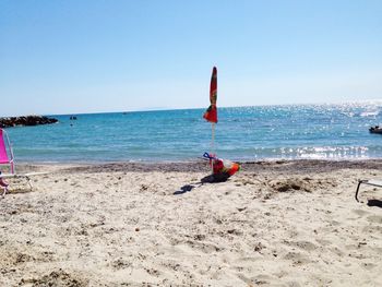 Scenic view of beach against clear blue sky