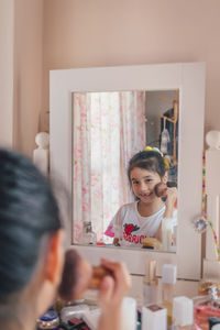 Beautiful little girl plays doing makeup