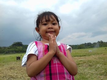 Portrait of a girl standing on field