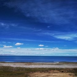 View of calm blue sea against cloudy sky