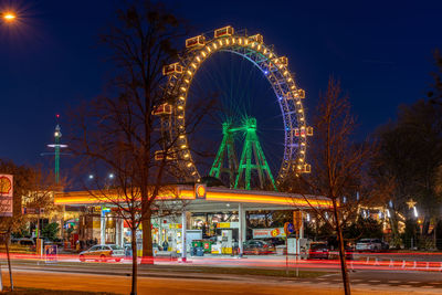 Illuminated ferris wheel at night