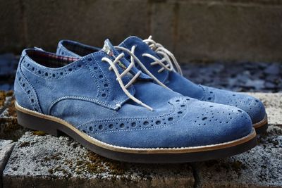 Close-up of shoes on stones