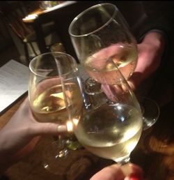 Close-up of cropped hand holding beer glass