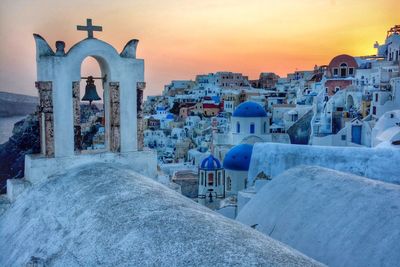 Built structures against sky at sunset