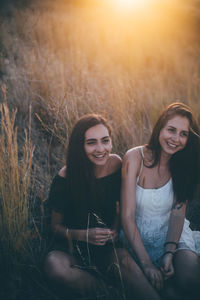 Portrait of a smiling young woman sitting outdoors