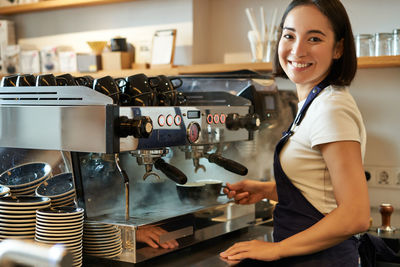 Portrait of young woman holding coffee