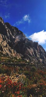 Low angle view of mountain range against blue sky