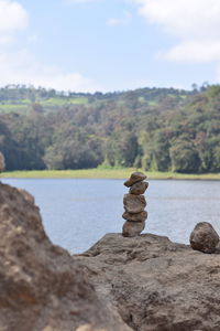 Stack of rocks on shore against sky