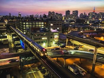 High angle view of illuminated highway and buildings in city at night