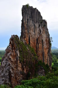 Rock formation on cliff against sky