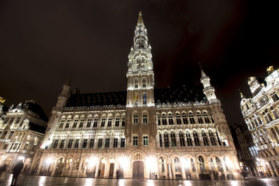 Low angle view of illuminated building against sky at night