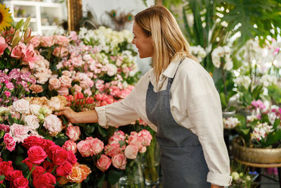 Young woman picking flowers