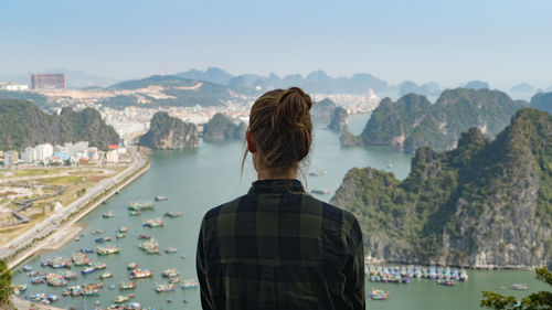 Rear view of man looking at bay