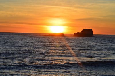 Scenic view of sea against orange sky