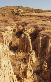 View of rock formations on landscape against sky