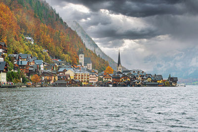 Scenic view of sea by buildings against sky