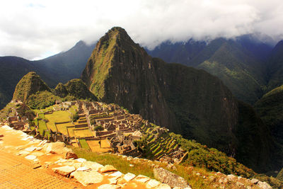 Scenic view of mountains against cloudy sky