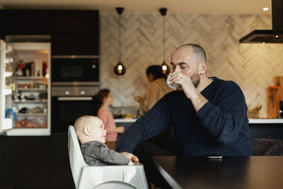 Father with baby at table