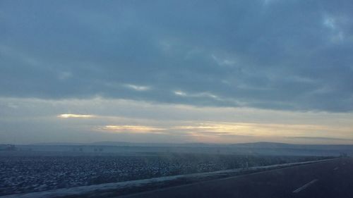 Scenic view of landscape against sky at sunset