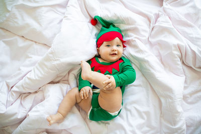 High angle view of cute baby boy sleeping on bed at home