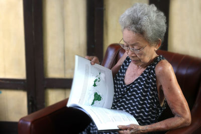 Midsection of woman reading book