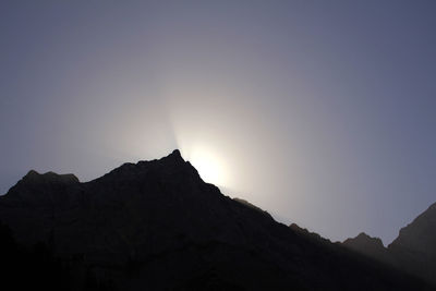 Low angle view of silhouette mountains against clear sky