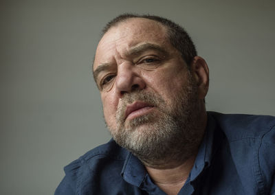 Portrait of man wearing hat against gray background
