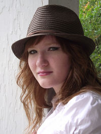 Side view portrait of young woman wearing hat
