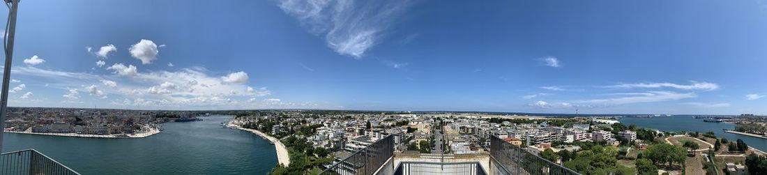 High angle view of townscape by sea against sky