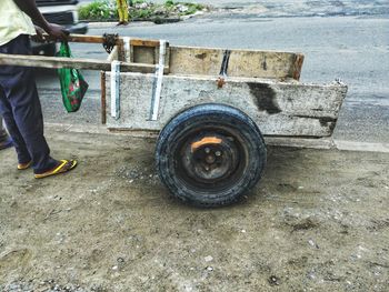 Low section of man working on street in city