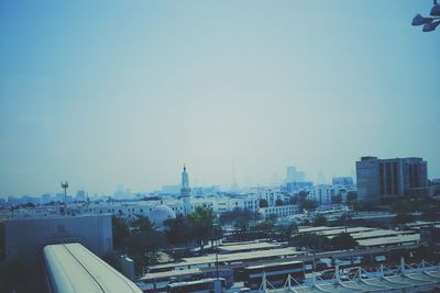 Cityscape against clear blue sky