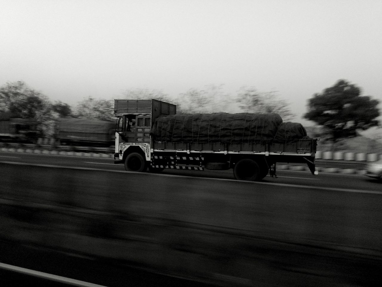 BUS ON ROAD AGAINST SKY