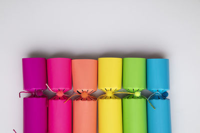 Close-up of multi colored drinking straws against white background