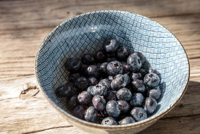 High angle view of black fruits in bowl on table