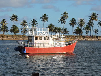 Ship moored on sea against sky