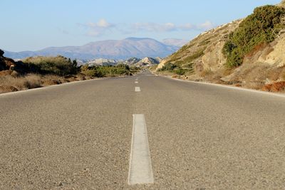 Road amidst mountains against sky