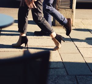 Low section of people walking on street