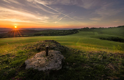 Scenic view of field against sky during sunset